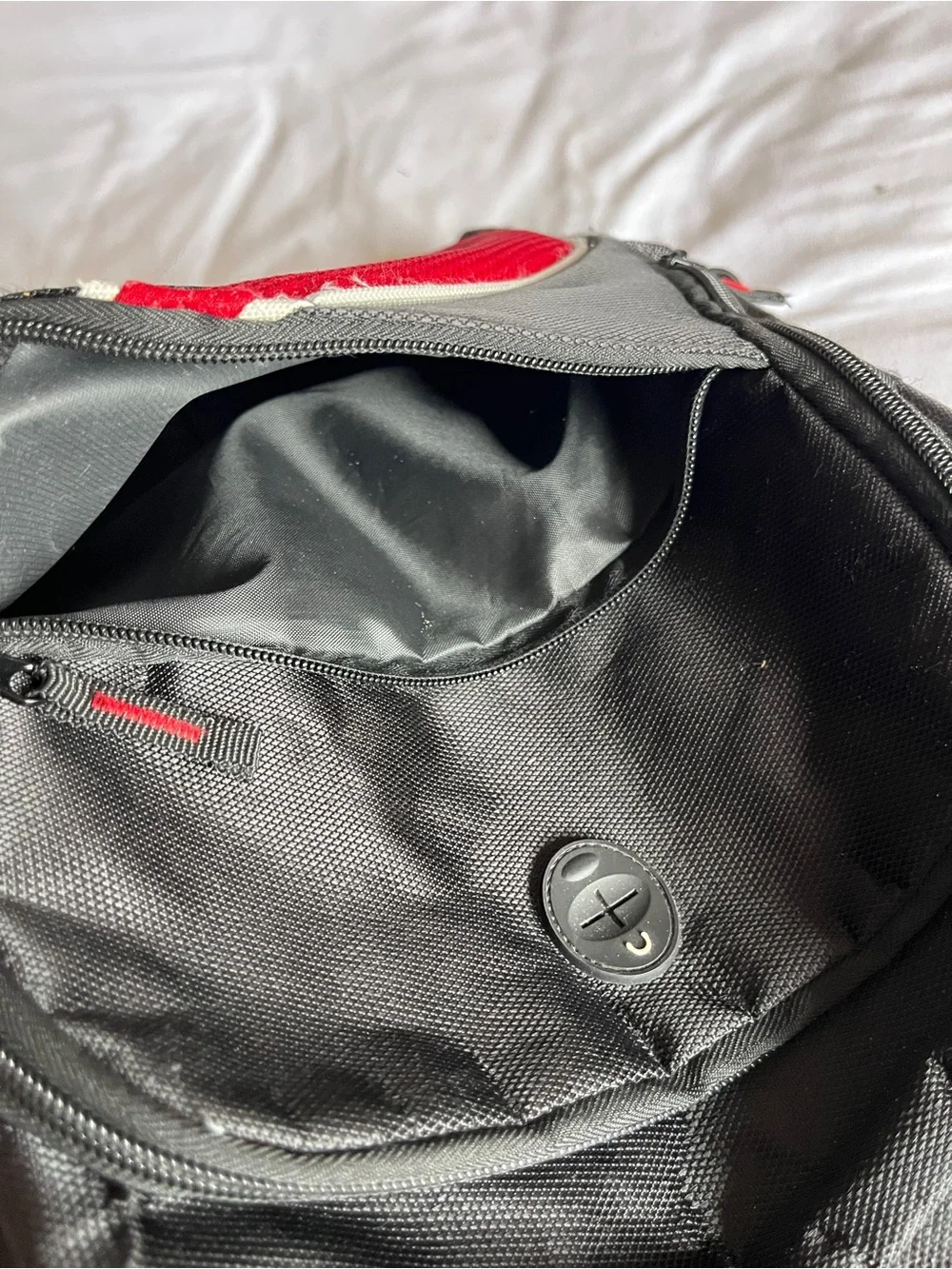 Black & Red Multi-Pocket Backpack with Media Port & Mesh Side Pockets